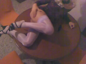 Blond crossdresser plays on the table