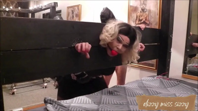 Dizzy Miss Sizzy is gagged and put in the stocks