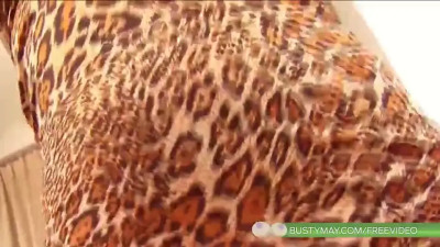 Ladyboy in leopard dress strips and teases with huge tits on sofa